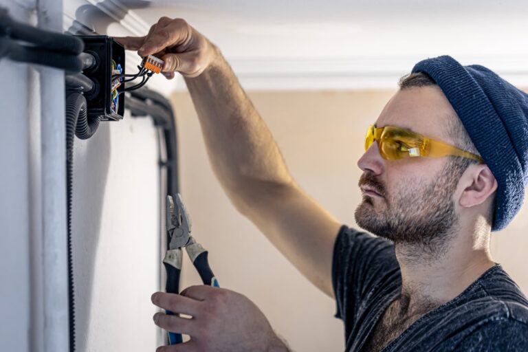 electrician-is-mounting-electric-sockets-white-wall-indoors-min-scaled.jpg